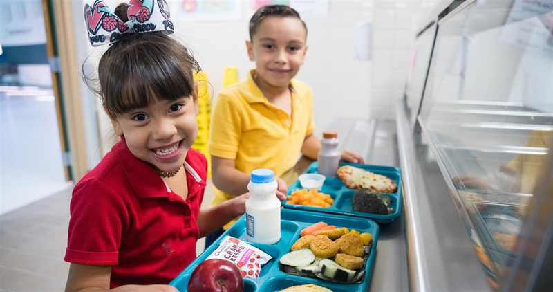 SISD students holding meals
